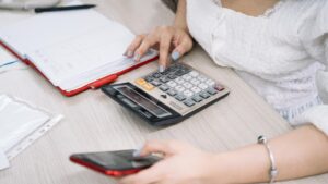 Personne calculant son budget face aux changements du 1er août 2026